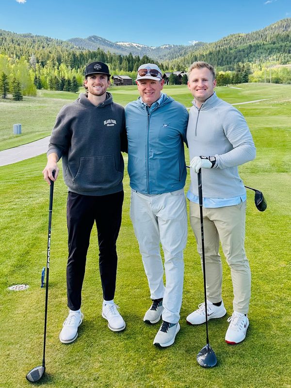 Tom Freeman on a golf course with his two sons